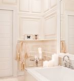 Bathroom with white paneling along the wall