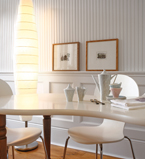 White dining room with white winscot along the wall with panels and baseboards