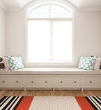 White wall with a large window with white casing around the window