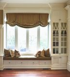 Large front window with white casing along window and white moulding along the ceiling and wall