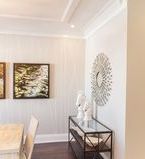 Corner photo of dining room with crown moulding and baseboard