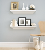 Light blue and grey wall with a white baseboard