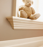 Beige walls with white casing around the window and white baseboards
