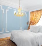 Bedroom with blue wall and white moulding
